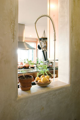 A windowsill opens into the kitchen from the hallway.